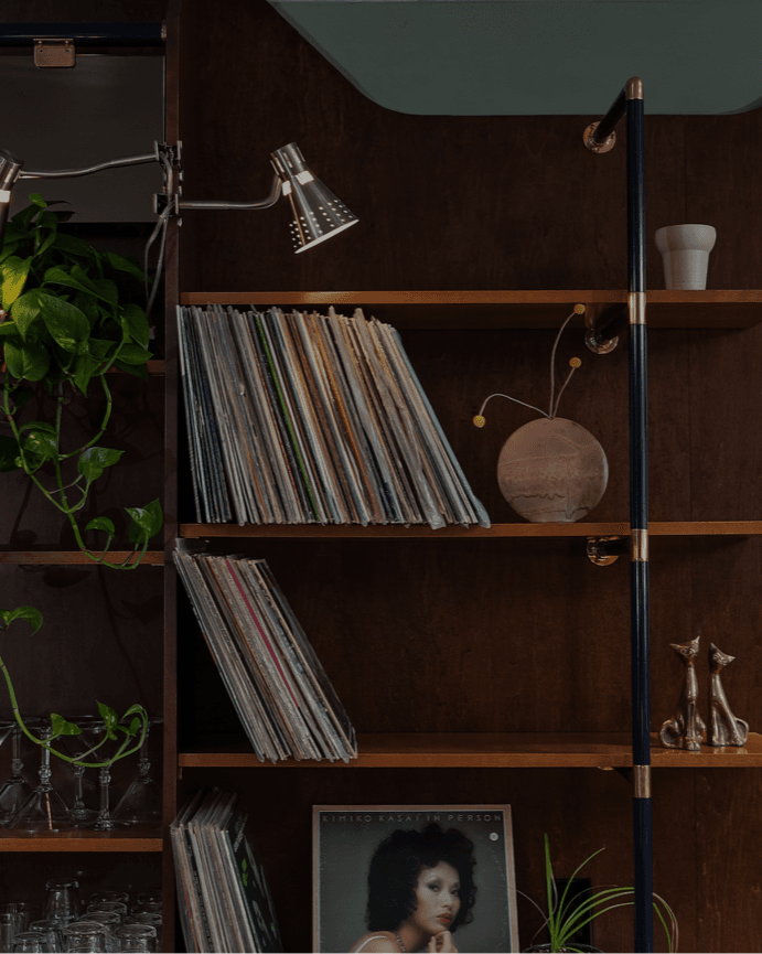 A Chinatown record bar — shelves of vinyl, plants and warm light